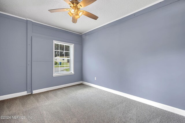 carpeted spare room with a textured ceiling and ceiling fan