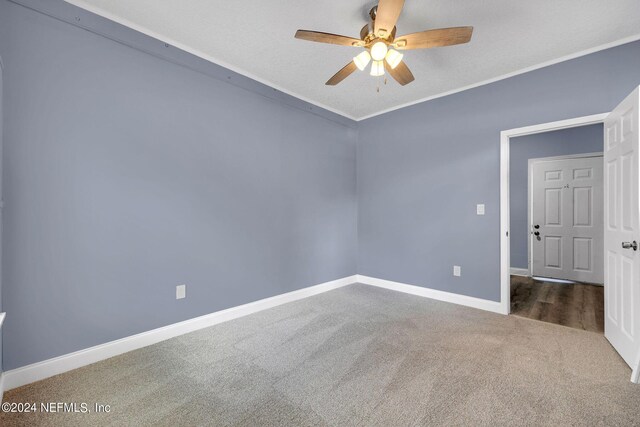 spare room featuring ornamental molding, a textured ceiling, ceiling fan, and carpet