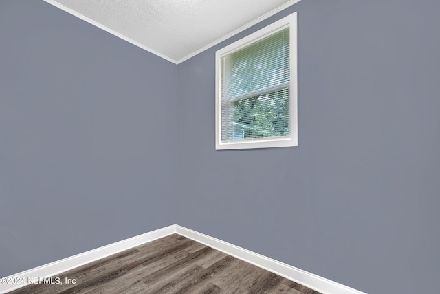 2916 Lippia Rd, Jacksonville, FL 32209 - unfurnished room featuring baseboards, a textured ceiling, crown molding, and dark wood finished floors
