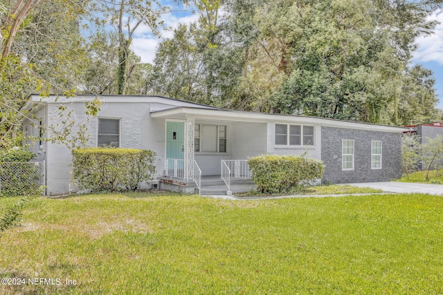 2916 Lippia Rd, Jacksonville, FL 32209 - view of front of home with a front lawn, covered porch, and fence