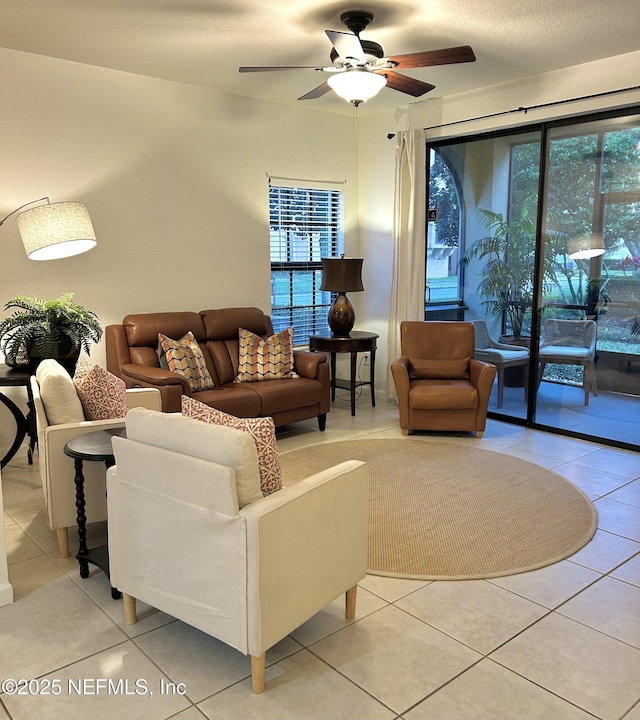 tiled living room featuring ceiling fan