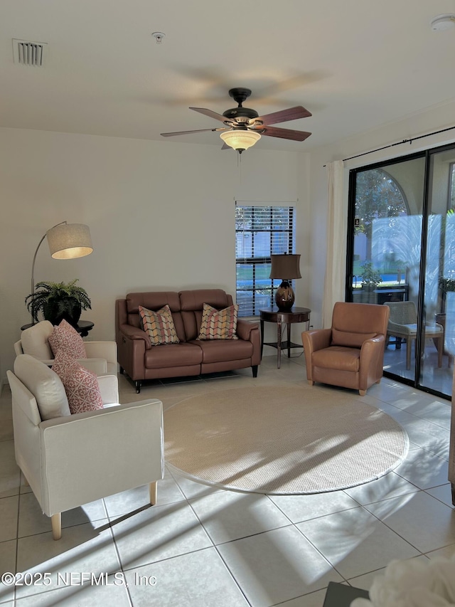 tiled living room with ceiling fan