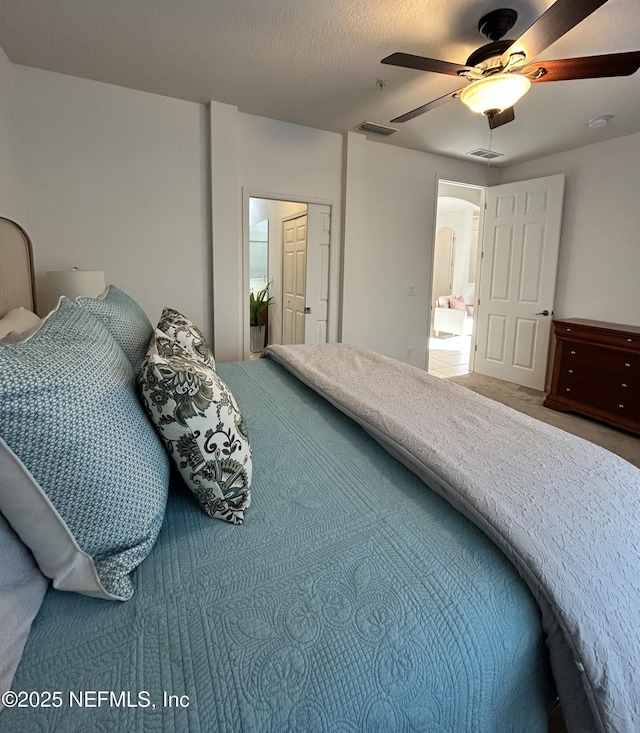 bedroom featuring connected bathroom and ceiling fan