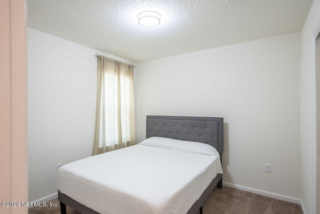 carpeted bedroom with a textured ceiling