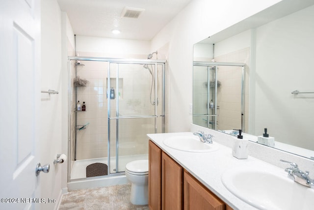 bathroom with vanity, toilet, and an enclosed shower