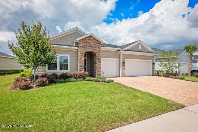 view of front of house featuring a front yard and a garage