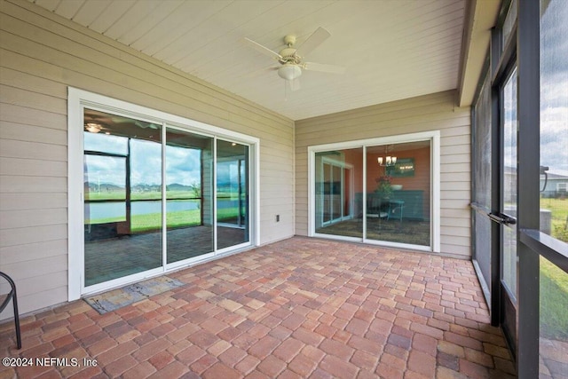 unfurnished sunroom with ceiling fan