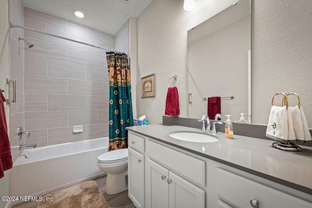 full bathroom featuring hardwood / wood-style floors, toilet, shower / tub combo, and vanity