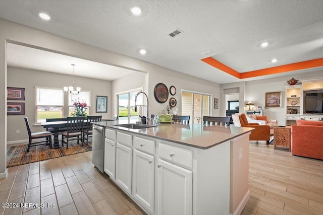 kitchen featuring an island with sink, light hardwood / wood-style flooring, a healthy amount of sunlight, and sink