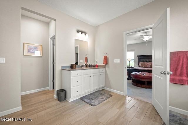 bathroom with vanity, hardwood / wood-style floors, and ceiling fan