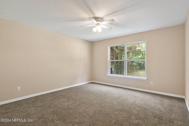 spare room featuring a textured ceiling, carpet flooring, and ceiling fan