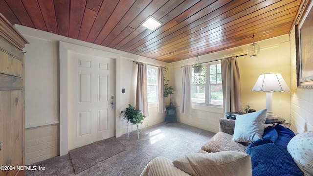 carpeted foyer with wood ceiling