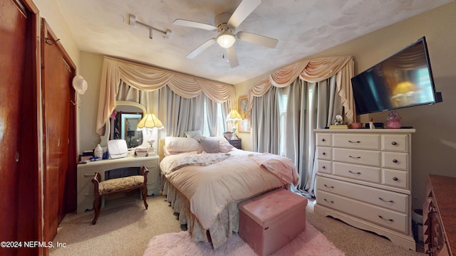 carpeted bedroom featuring ceiling fan