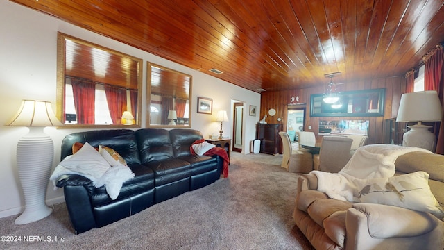 living room with a healthy amount of sunlight, wood ceiling, and wood walls