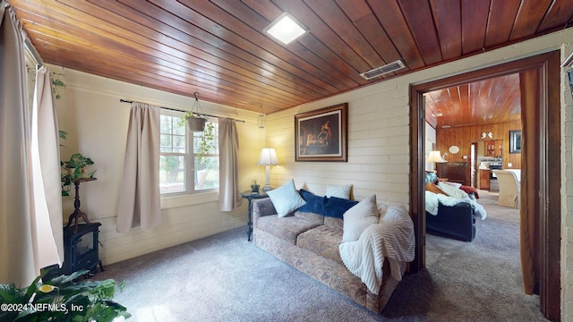 living area with carpet floors, wood walls, and wooden ceiling