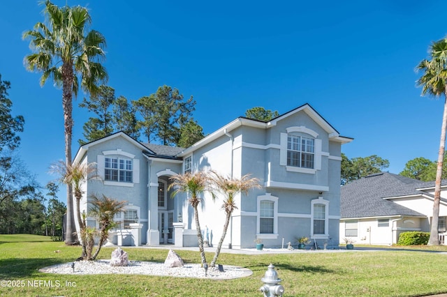 view of front of property with a front lawn and stucco siding