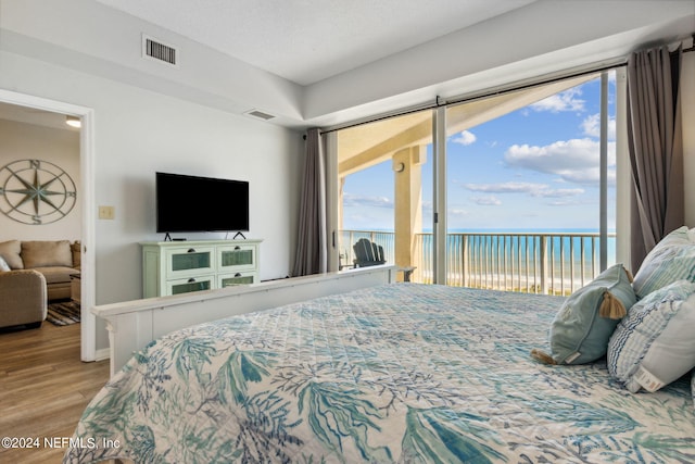 bedroom featuring hardwood / wood-style floors and access to exterior