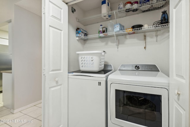 washroom with separate washer and dryer and light tile patterned floors