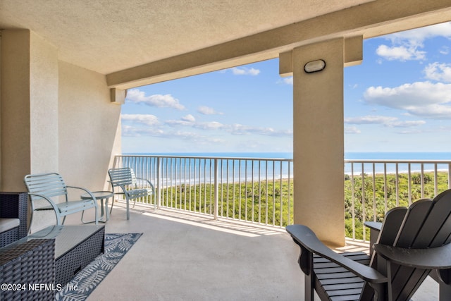 balcony with a view of the beach and a water view