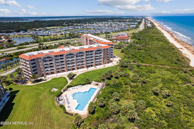 drone / aerial view featuring a water view and a beach view