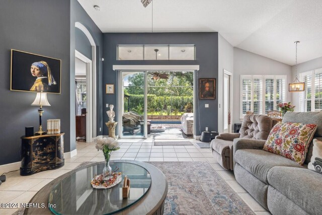 living room with vaulted ceiling and light tile patterned floors