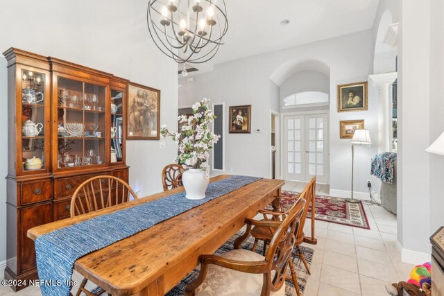 dining space featuring light tile patterned floors and an inviting chandelier