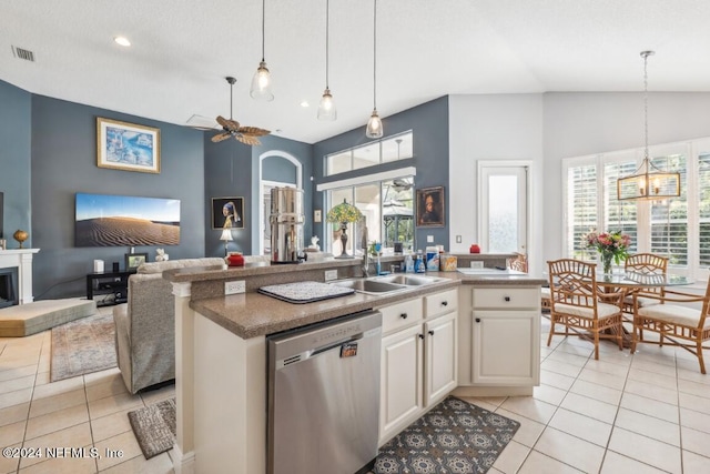 kitchen with a fireplace with raised hearth, visible vents, open floor plan, a sink, and dishwasher