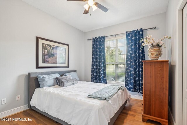 bedroom featuring ceiling fan and hardwood / wood-style floors