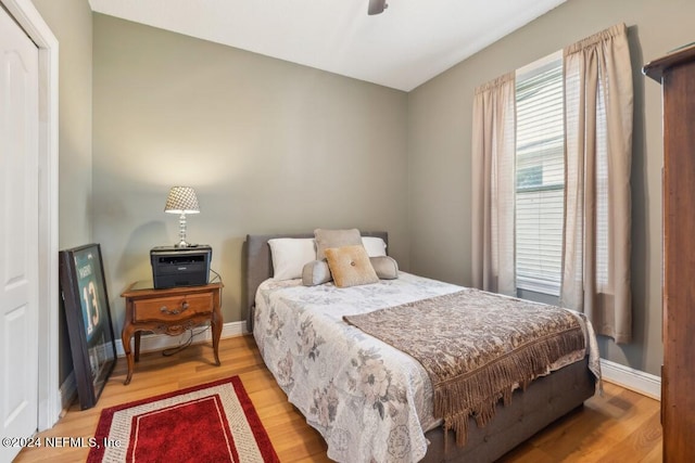 bedroom with light wood-style floors and baseboards