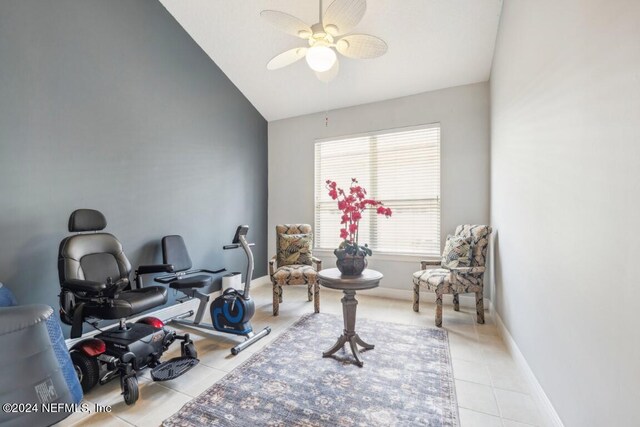 interior space featuring ceiling fan, light tile patterned floors, and vaulted ceiling