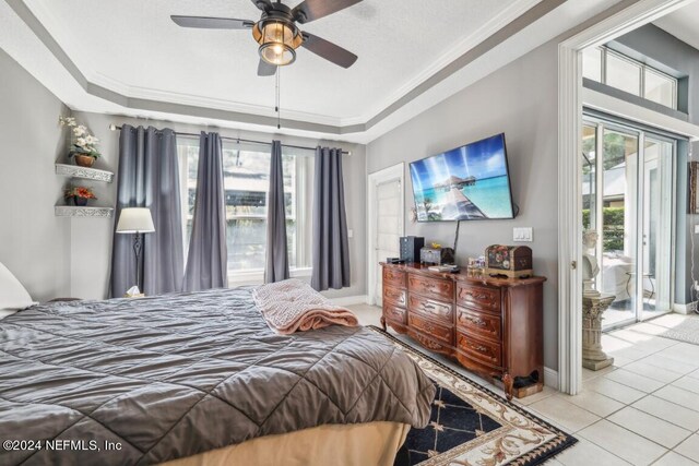 bedroom featuring multiple windows, ceiling fan, a raised ceiling, and crown molding