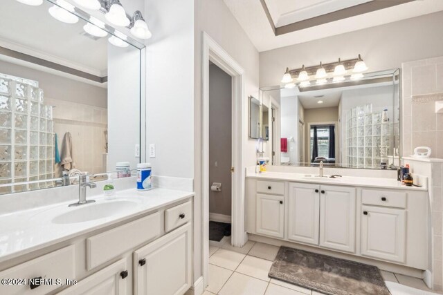 bathroom featuring ornamental molding, vanity, a shower, and tile patterned flooring