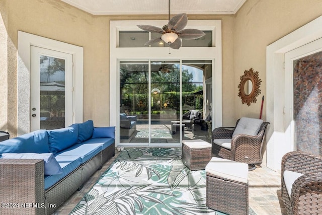 view of patio with an outdoor living space and ceiling fan