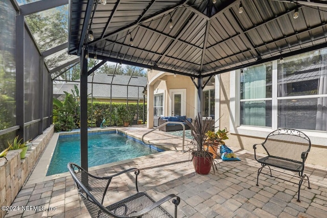 view of swimming pool featuring a gazebo, a patio, and glass enclosure