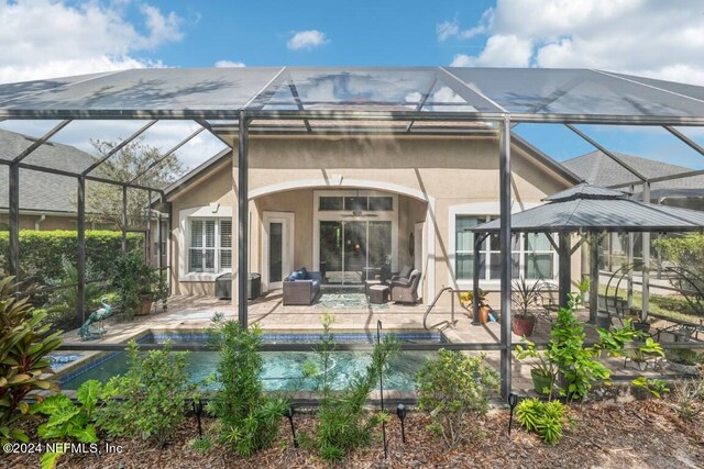 rear view of house featuring a patio area and a lanai