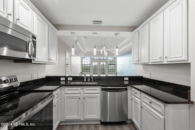 kitchen featuring dark stone counters, sink, appliances with stainless steel finishes, and white cabinetry