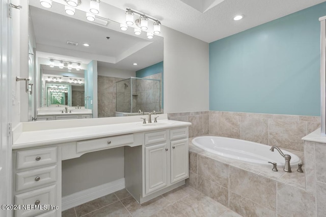 bathroom featuring vanity, tile patterned flooring, and shower with separate bathtub