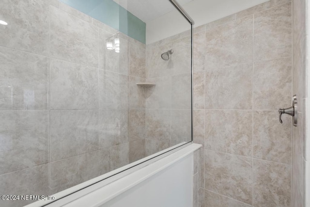 bathroom with a tile shower