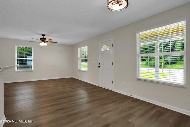 entryway with ceiling fan, a textured ceiling, and dark hardwood / wood-style flooring