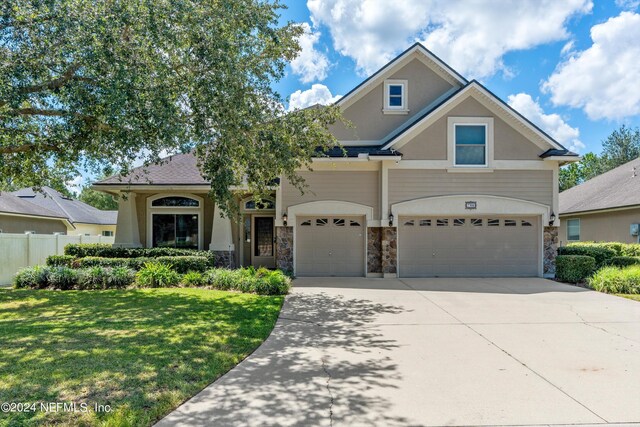 view of front of property with a garage and a front lawn