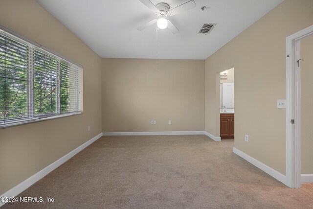 interior space featuring light carpet and ceiling fan