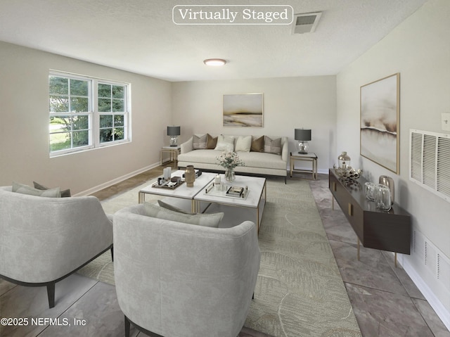 living room featuring visible vents and baseboards