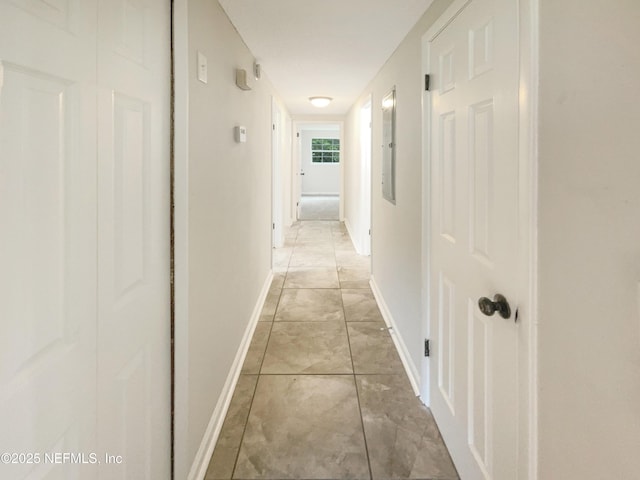 corridor featuring baseboards