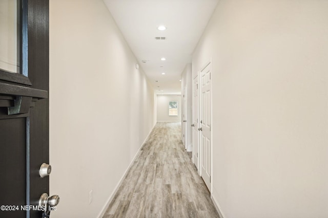 corridor featuring light hardwood / wood-style floors