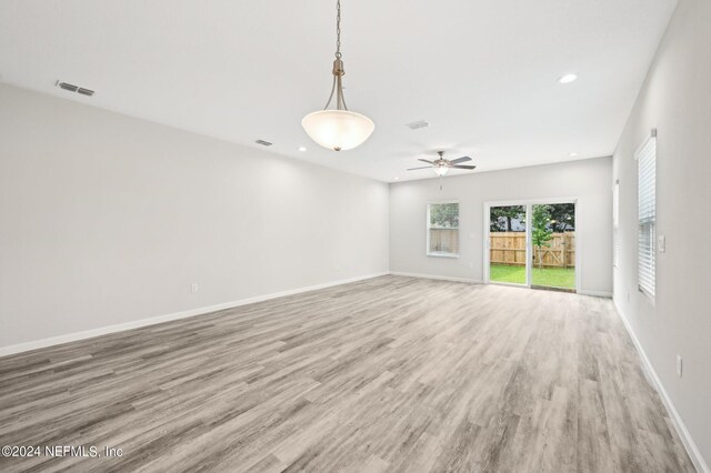 unfurnished room with ceiling fan and light wood-type flooring