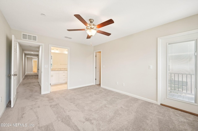 unfurnished bedroom with ceiling fan, light colored carpet, access to outside, and connected bathroom