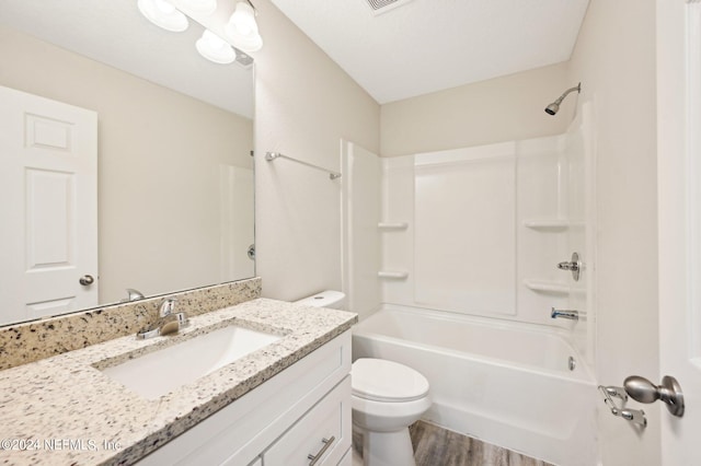 full bathroom featuring hardwood / wood-style flooring, vanity, toilet, and shower / tub combination