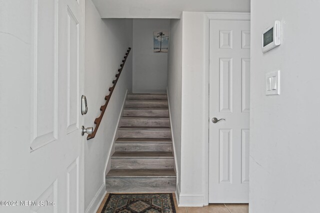 stairs with tile patterned flooring