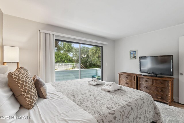 bedroom featuring access to outside and hardwood / wood-style floors