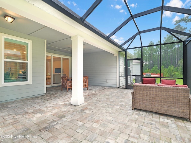 view of patio with glass enclosure and an outdoor hangout area